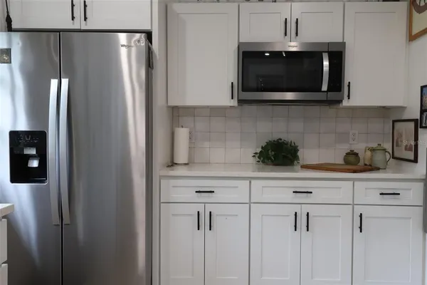 a kitchen with stainless steel appliances granite countertop a stove and a refrigerator
