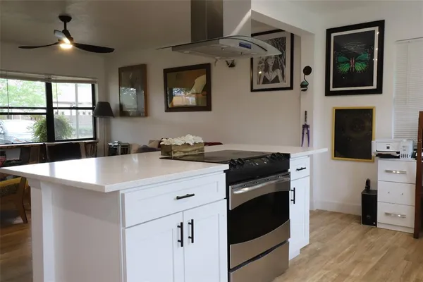 a living room with furniture a flat screen tv and a large window