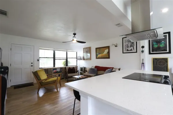 a kitchen with a table chairs and white cabinets