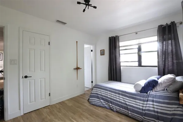 a view of a room with wooden floor and a bathroom