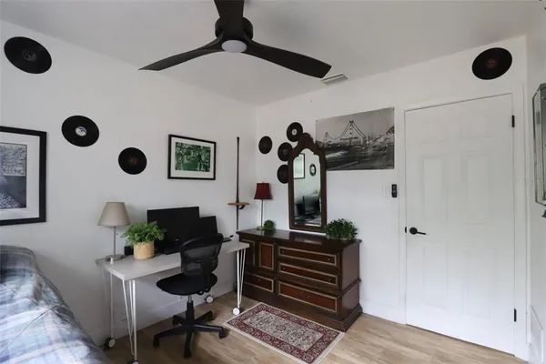 a bed room with a bed and painting on the wall