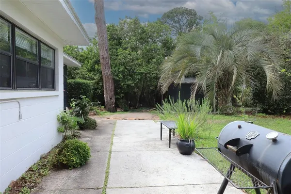 a view of a house with backyard and sitting area