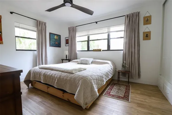 a large bed sitting in a bedroom next to a window