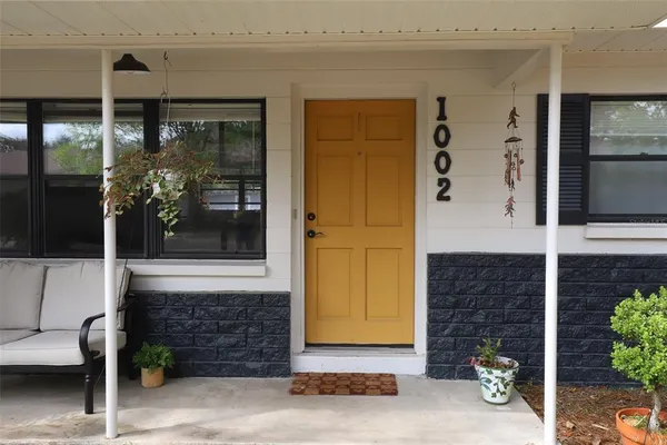 a front view of a house with outdoor seating