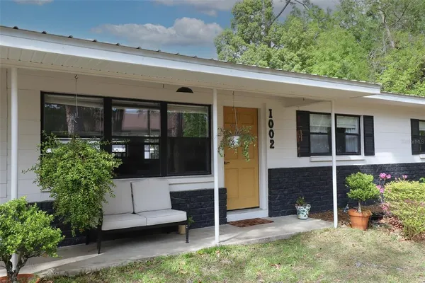 a view of a patio with table and chairs and potted plants