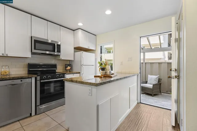 a kitchen with a sink stove and refrigerator