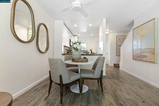 a dining room with furniture and a mirror