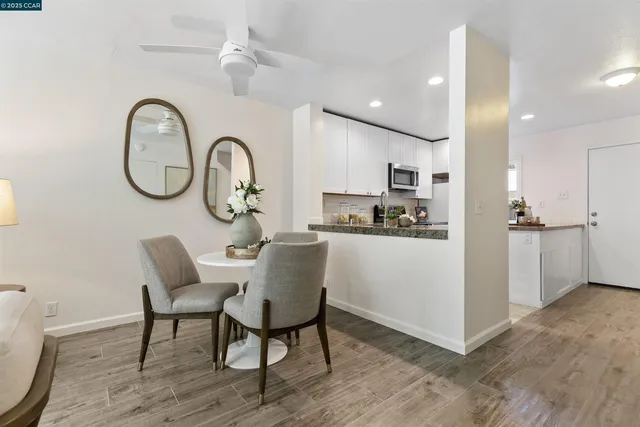 a kitchen with a table chairs and a refrigerator