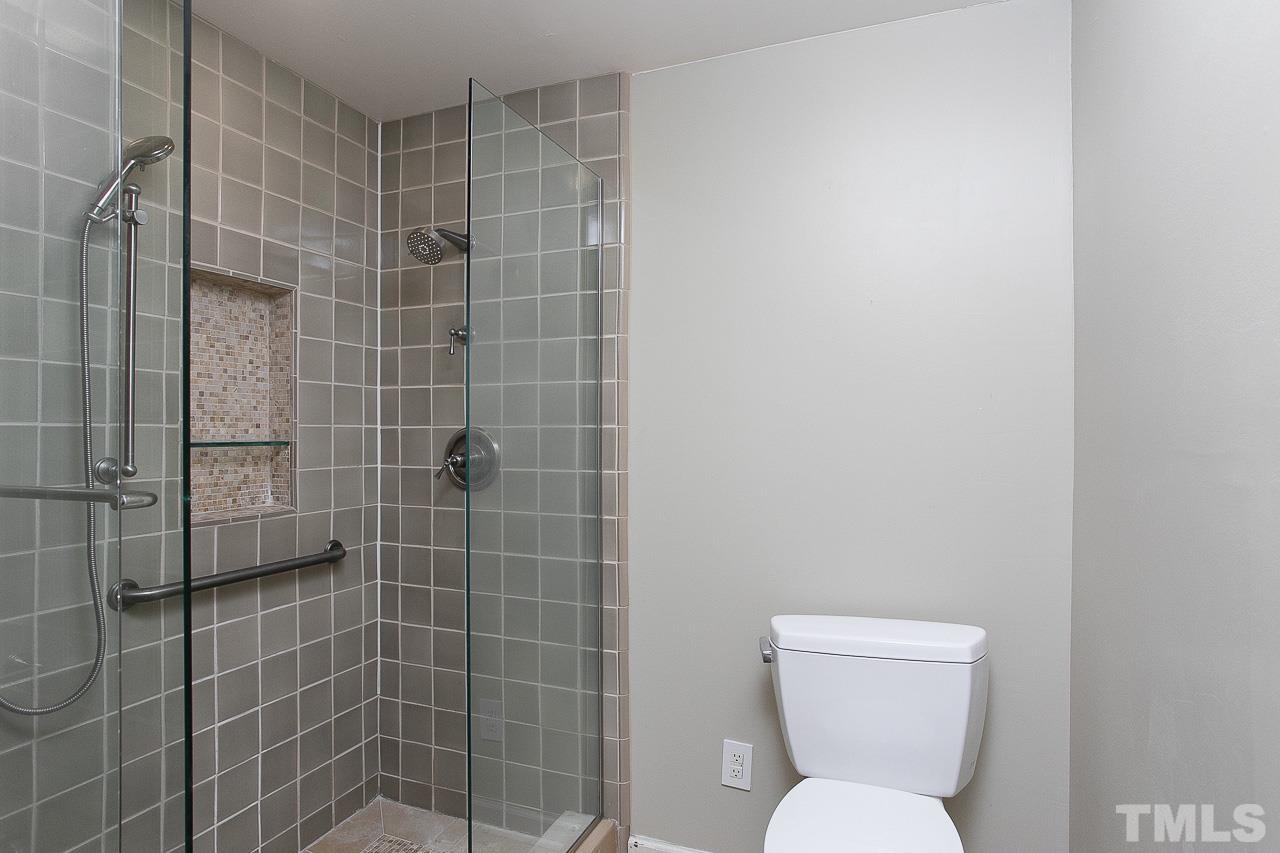 4901 Rampart Street Raleigh, NC 27609 - Photo 22 of 29 a bathroom with a toilet sink and shower
