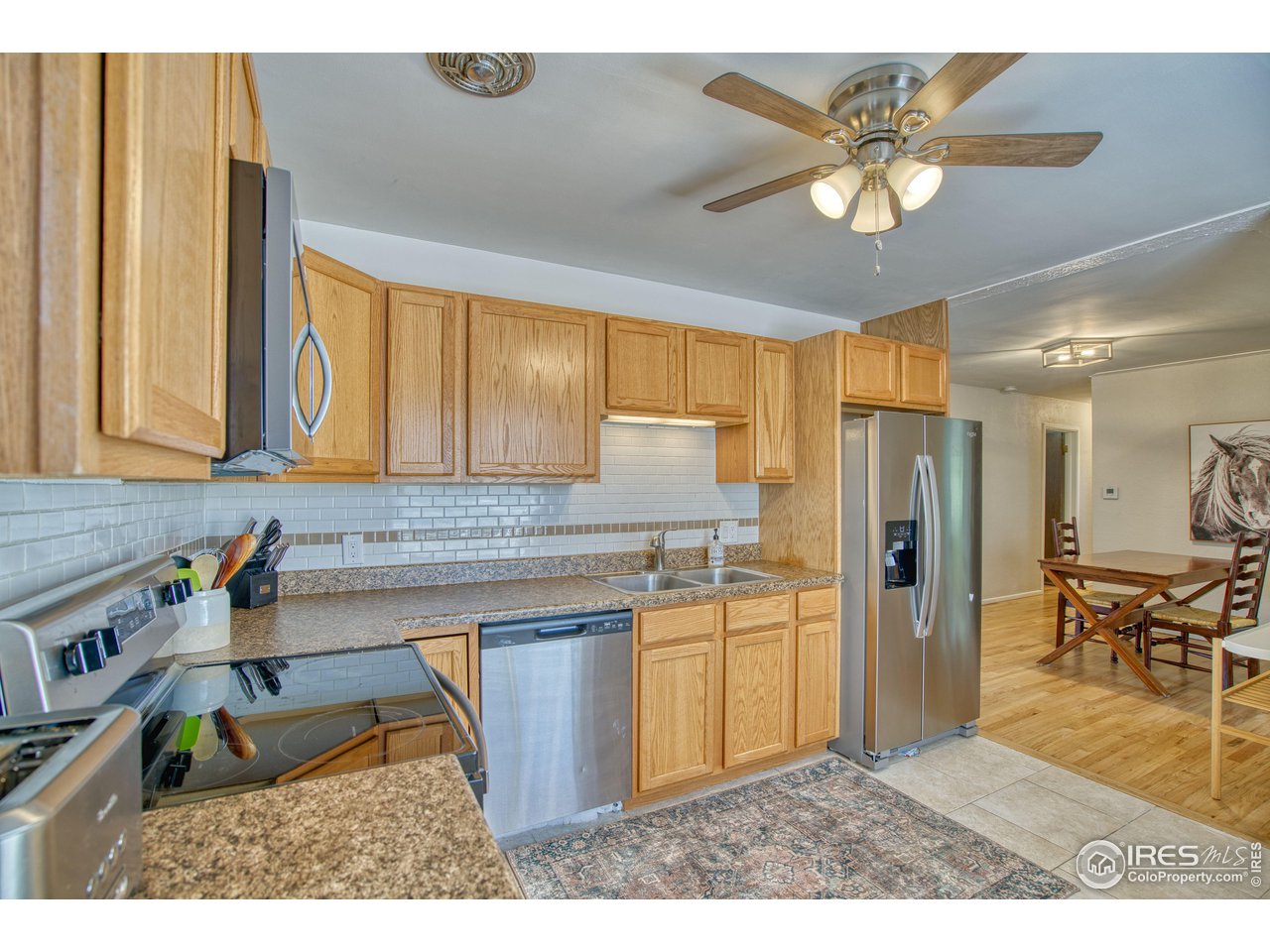 101 6th Street Frederick, CO 80530 - Photo 14 of 35 a kitchen with stainless steel appliances granite countertop a sink refrigerator stove and microwave