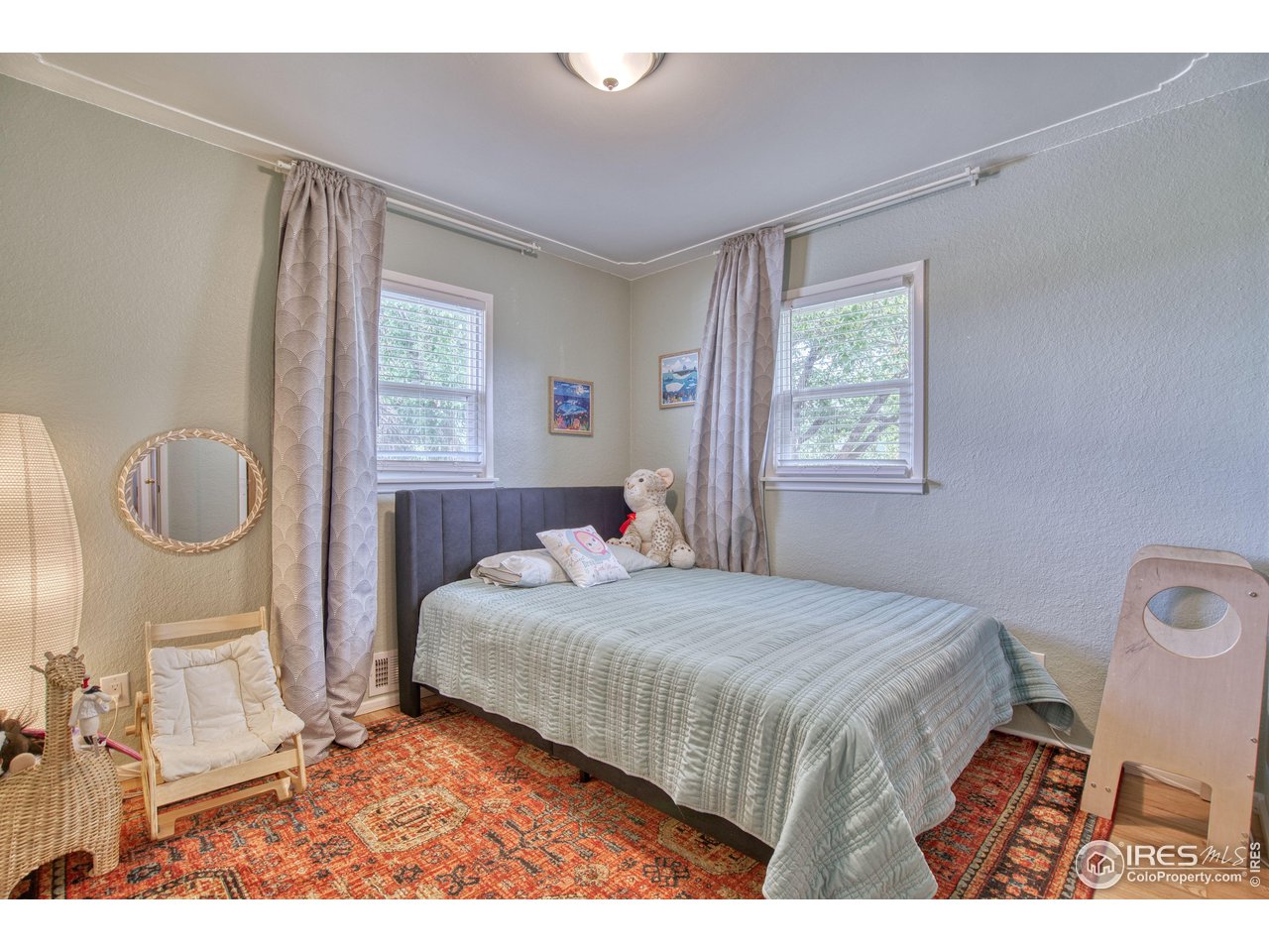 101 6th Street Frederick, CO 80530 - Photo 20 of 35 a bedroom with a bed a mirror and window