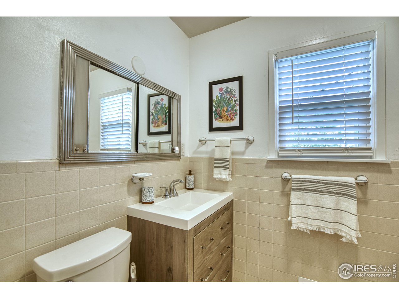 101 6th Street Frederick, CO 80530 - Photo 21 of 35 a bathroom with a sink mirror and a bathtub