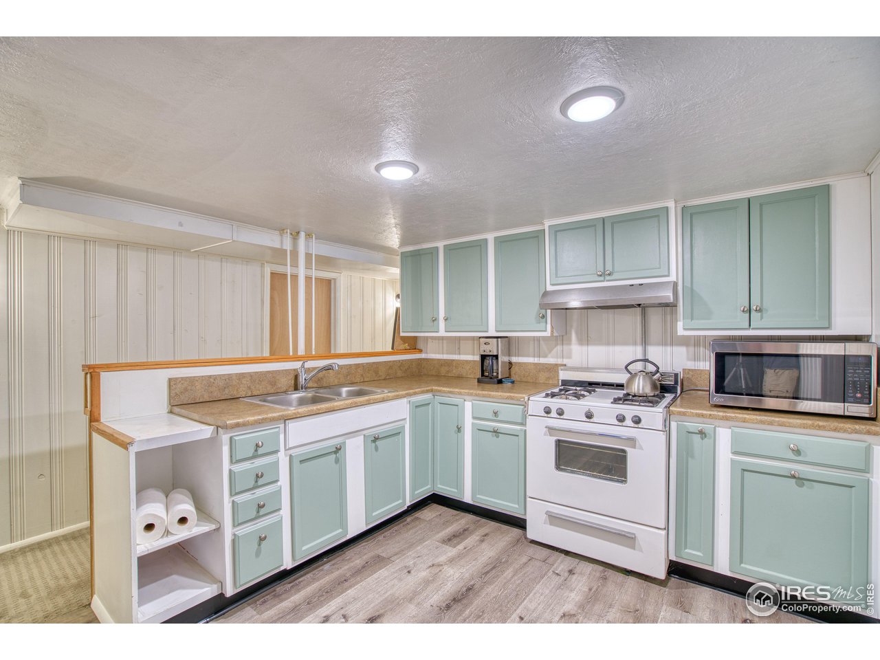 101 6th Street Frederick, CO 80530 - Photo 24 of 35 a kitchen with a stove top oven sink and cabinets