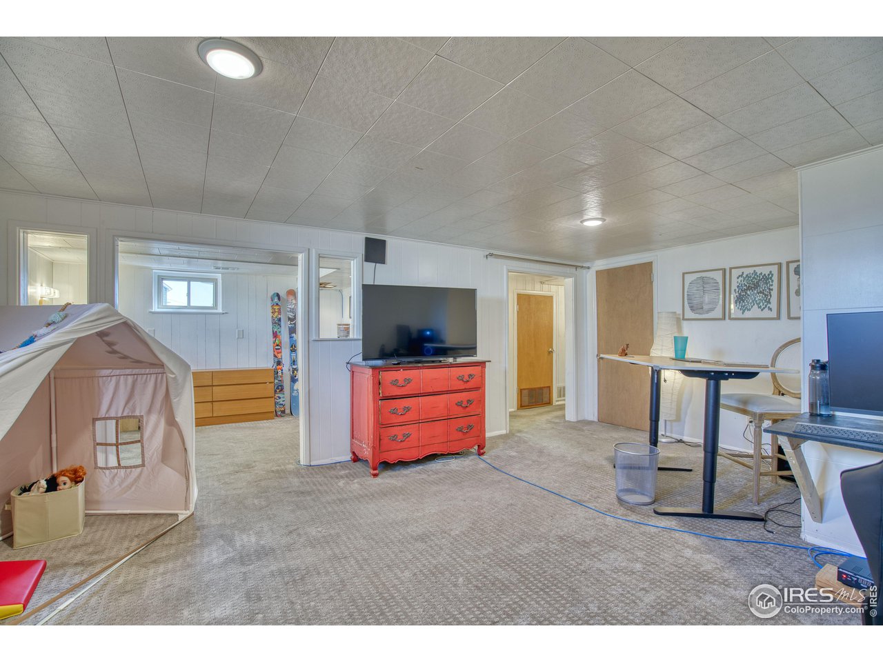 101 6th Street Frederick, CO 80530 - Photo 26 of 35 a living room with furniture and a flat screen tv
