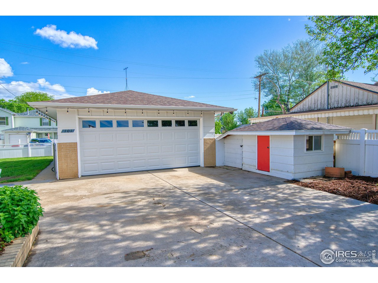 101 6th Street Frederick, CO 80530 - Photo 3 of 35 a front view of a house with a yard and garage