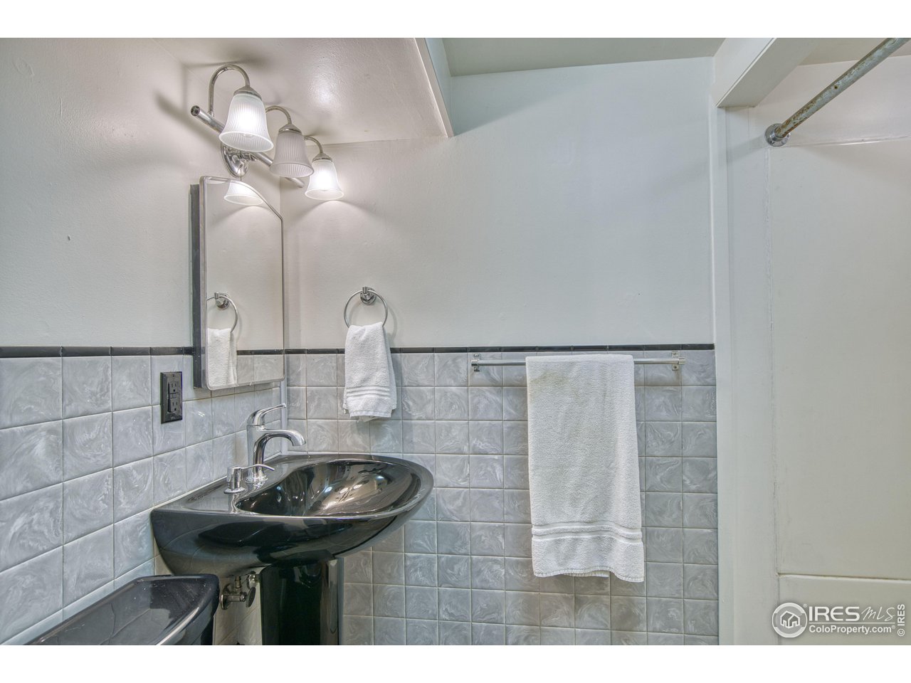 101 6th Street Frederick, CO 80530 - Photo 32 of 35 a bathroom with a sink and a mirror