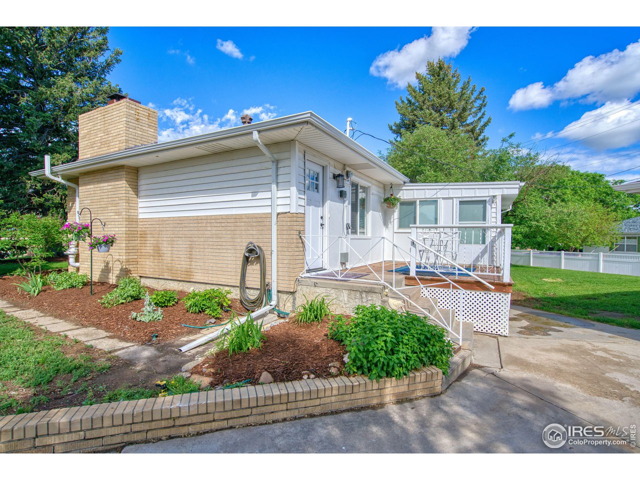 101 6th Street Frederick, CO 80530 - Photo 7 of 35 a front view of a house with garden