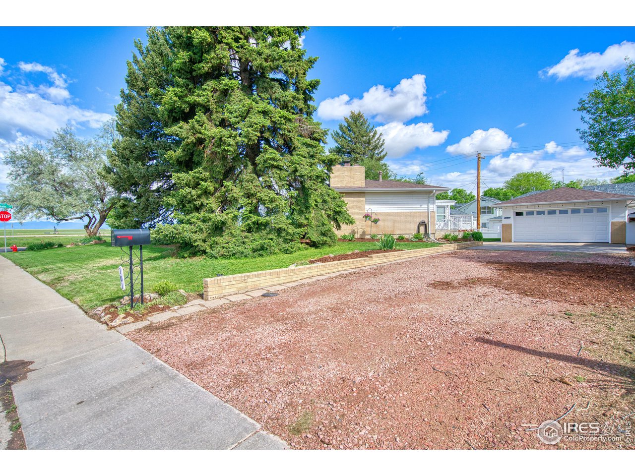 101 6th Street Frederick, CO 80530 - Photo 8 of 35 a front view of a house with a yard and garage