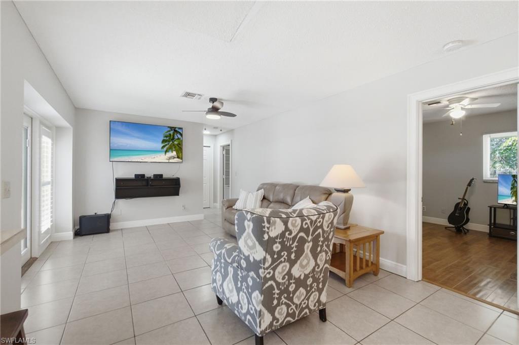 3022 47th Street Southwest Naples, FL 34116 - Photo 22 of 46 Spacious living area featuring light-toned tile flooring throughout