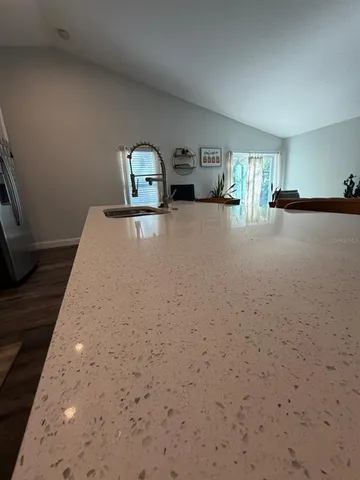 a kitchen with granite countertop a sink and cabinets
