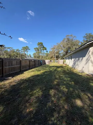 a view of a house with backyard sitting area and garden