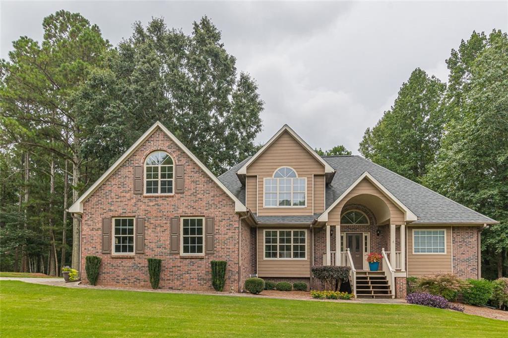 9051 Ephesus Church Road Villa Rica, GA 30180 - Photo 1 of 1 a front view of a house with a garden