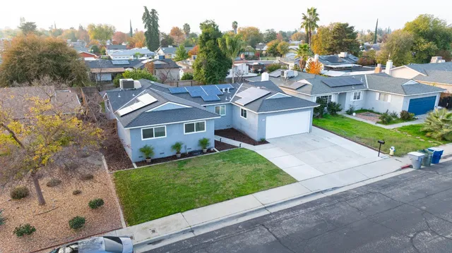 a aerial view of a house with a garden and trees
