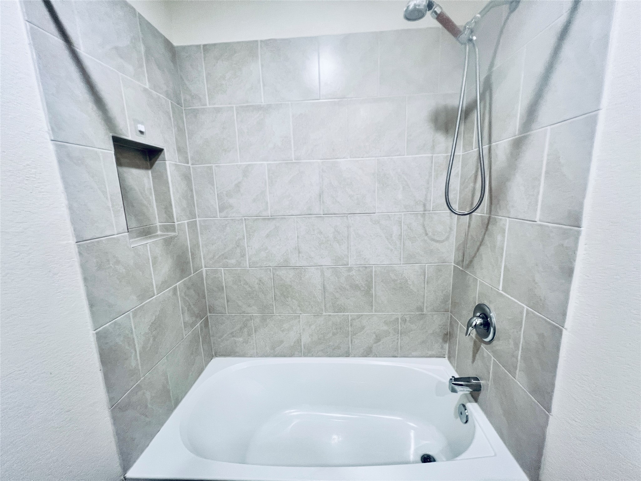 520 Locksley Cove Jarrell, TX 76537 - Photo 21 of 27 A pristine bathtub with a convenient built-in shower niche awaits.