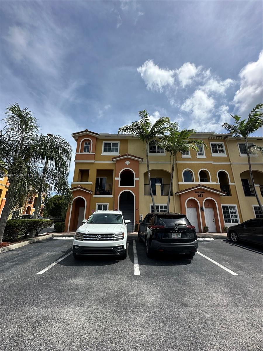 a front view of a house with parking space