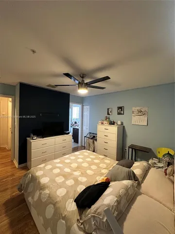 a bedroom with a large bed and a large window