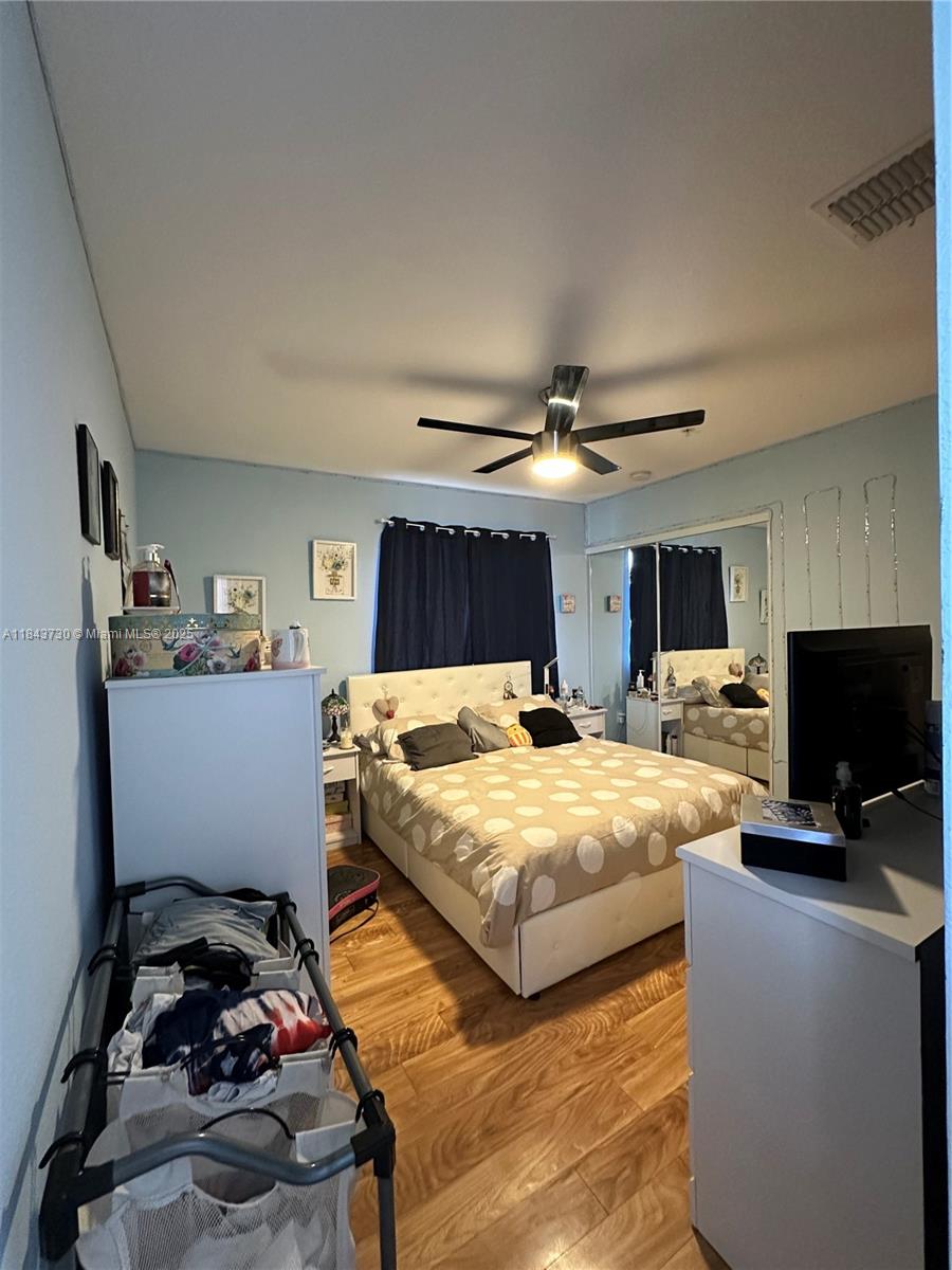 141 Northwest 2nd Avenue, Unit 2 Hallandale Beach, FL 33009 - Photo 13 of 21 a bedroom with bed and a flat screen tv