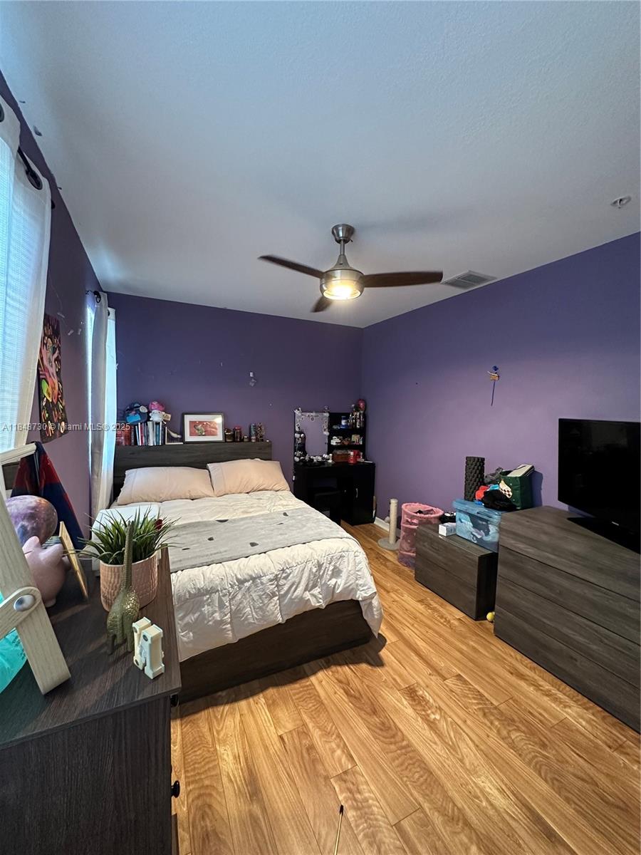 141 Northwest 2nd Avenue, Unit 2 Hallandale Beach, FL 33009 - Photo 15 of 21 a bedroom with a bed and wooden floor