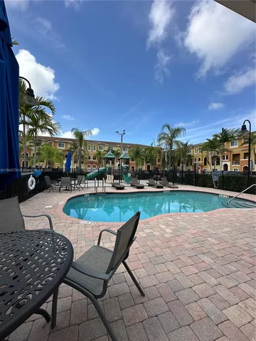 a view of a swimming pool with lounge chair