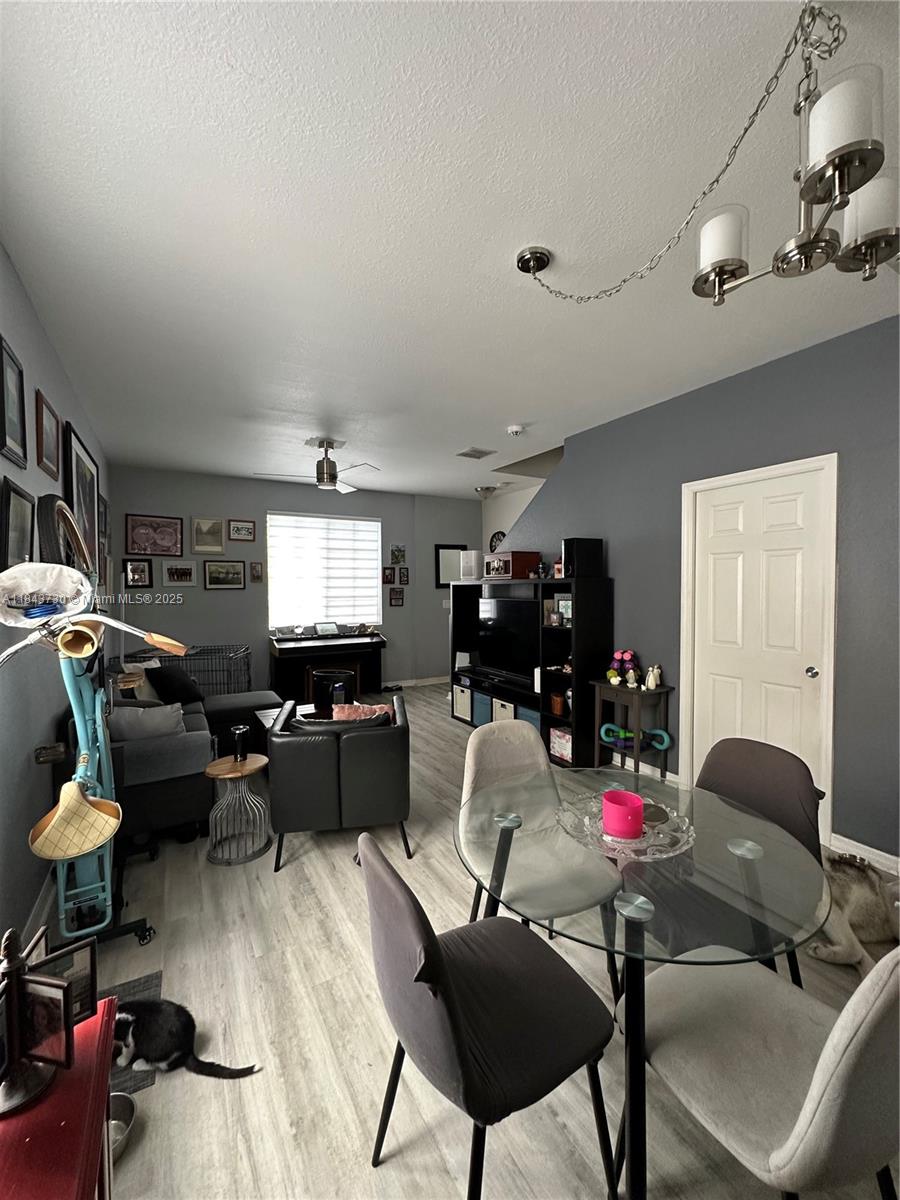 141 Northwest 2nd Avenue, Unit 2 Hallandale Beach, FL 33009 - Photo 7 of 21 a living room with furniture and a flat screen tv