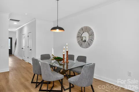 a dining room with furniture and a chandelier
