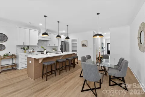 a view of kitchen with dining room and wooden floor