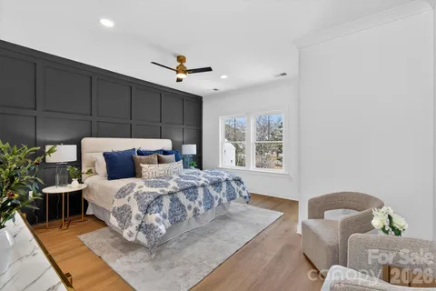 a bedroom with bed and wooden floor