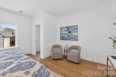 a bedroom with bed and window