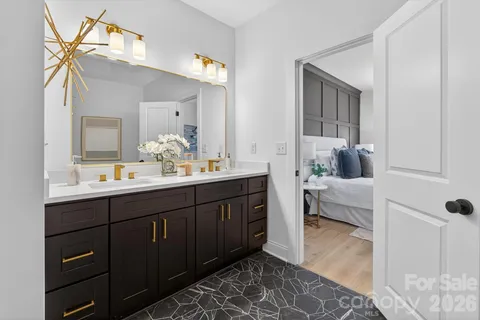 a bathroom with a double vanity sink and mirror