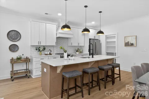 a kitchen with a sink a counter space and stainless steel appliances