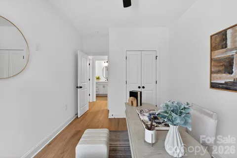 a view of a hallway with wooden floor and staircase