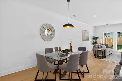 a dining room with furniture a rug and a chandelier