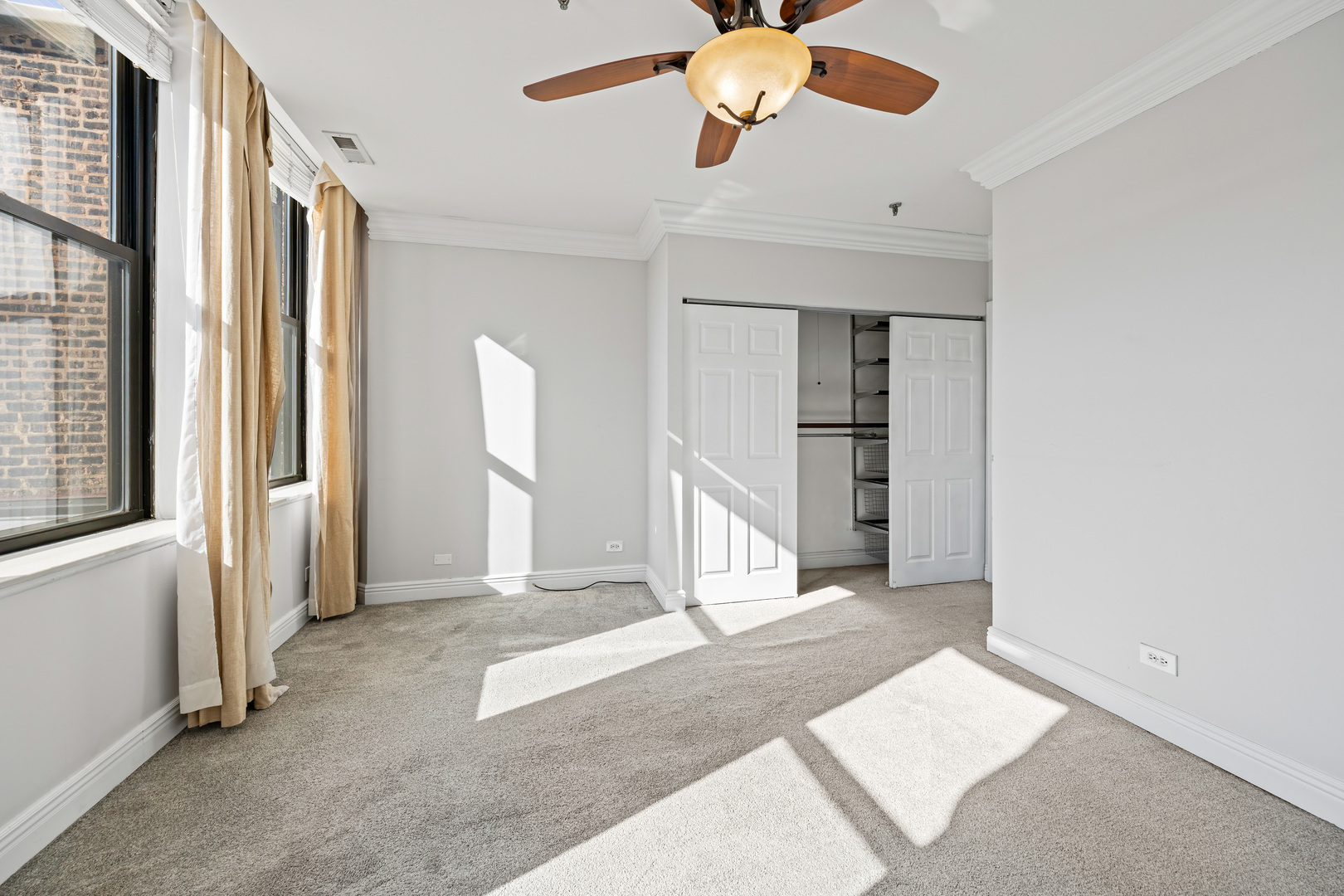 780 South Federal Street, Unit 407 Chicago, IL 60605 - Photo 18 of 20 an empty room with a ceiling fan and window