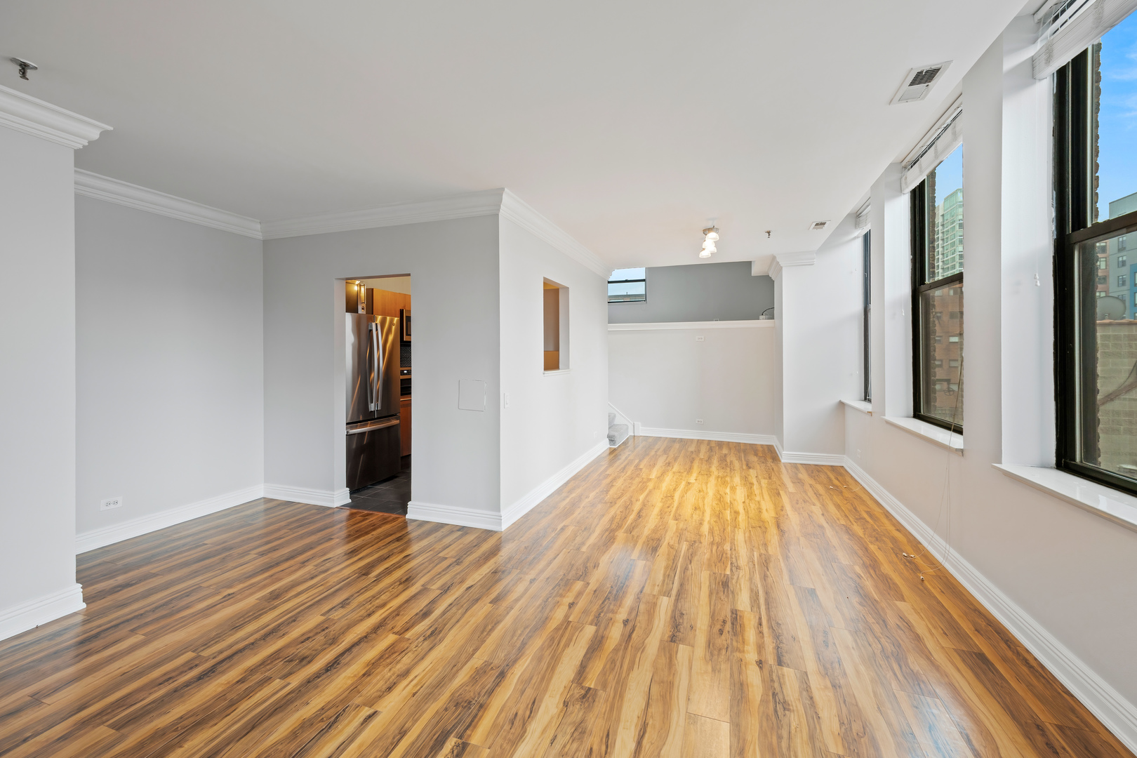 780 South Federal Street, Unit 407 Chicago, IL 60605 - Photo 5 of 20 an empty room with wooden floor and entrance