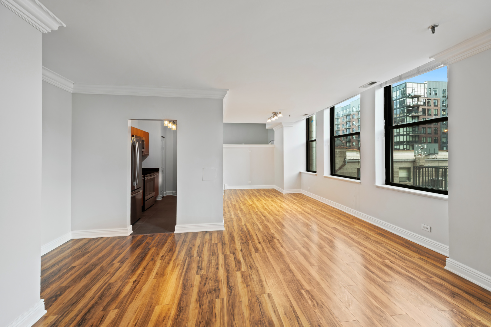 780 South Federal Street, Unit 407 Chicago, IL 60605 - Photo 8 of 20 a view of a bedroom with wooden floor and a window