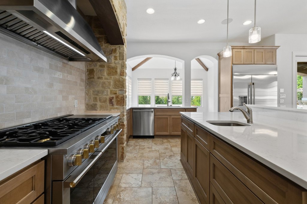 109 Largo Cove Austin, TX 78734 - Photo 8 of 40 An inviting kitchen with pristine white countertops and a large gas range.