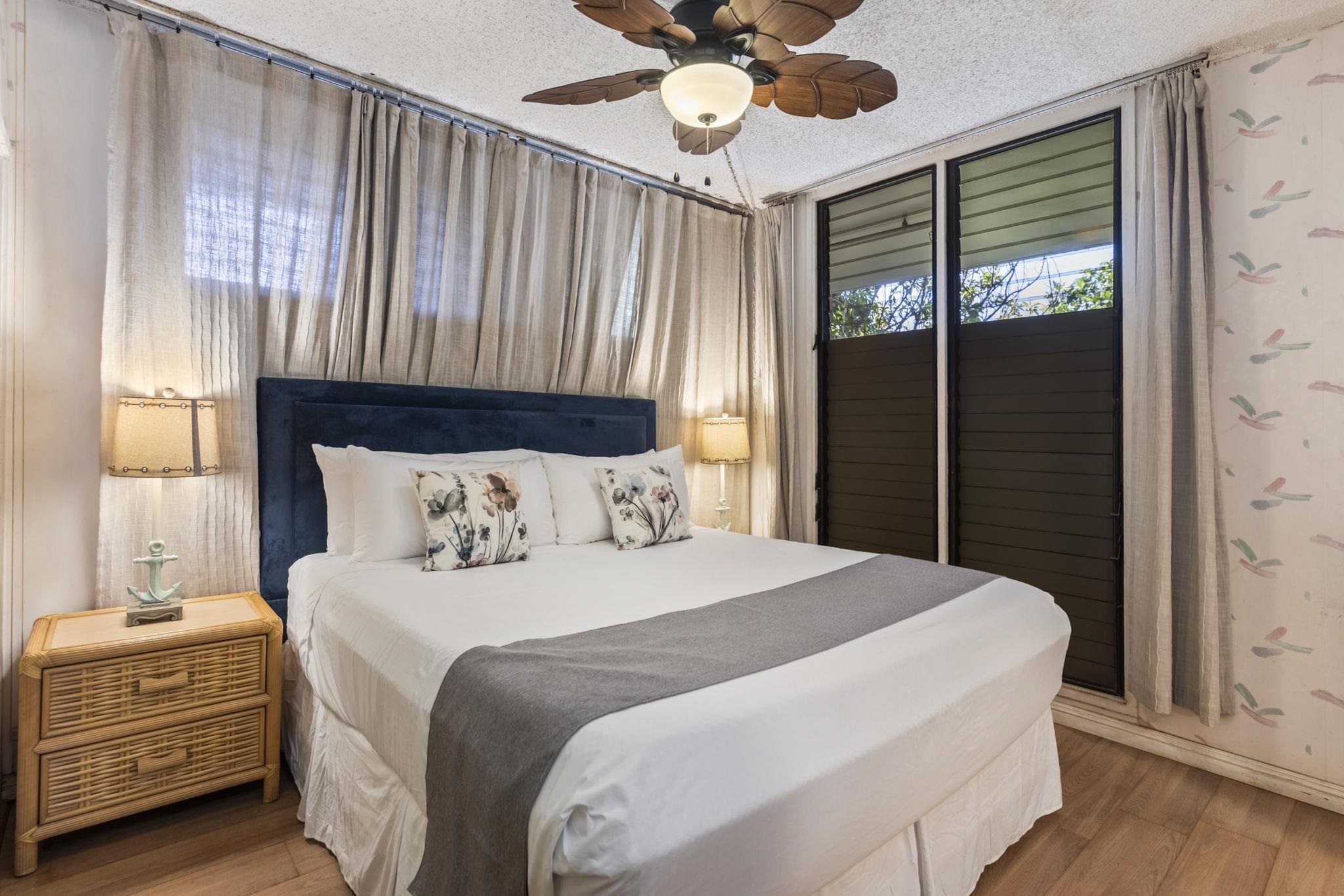 3875 Lower Honoapiilani Road, Unit B205 Lahaina, HI 96761 - Photo 13 of 28 a bedroom with a bed and a chandelier
