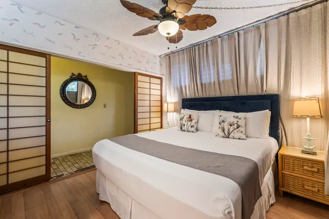 a bedroom with a large bed and a window