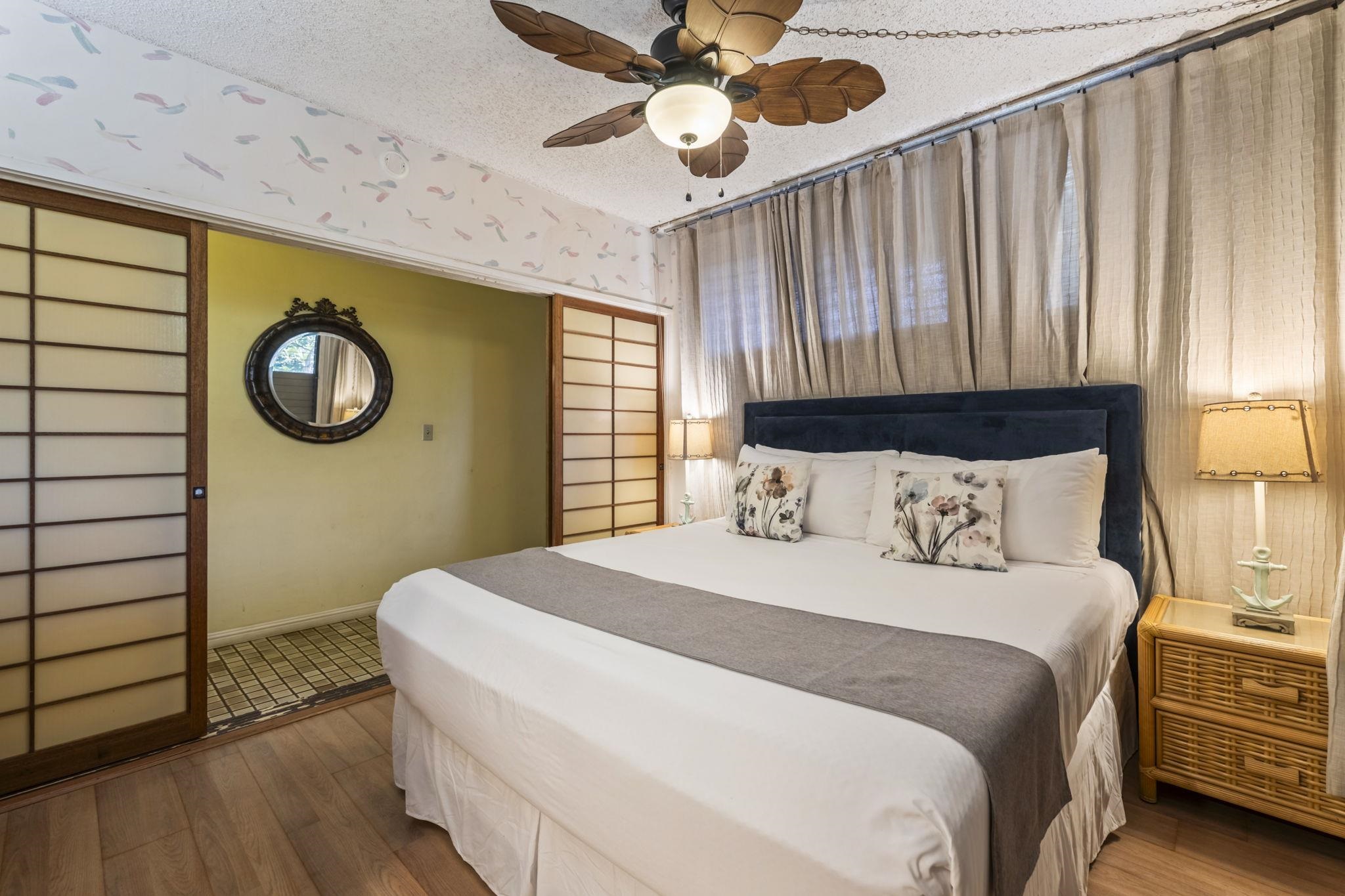 3875 Lower Honoapiilani Road, Unit B205 Lahaina, HI 96761 - Photo 14 of 28 a bedroom with a bed and a chandelier