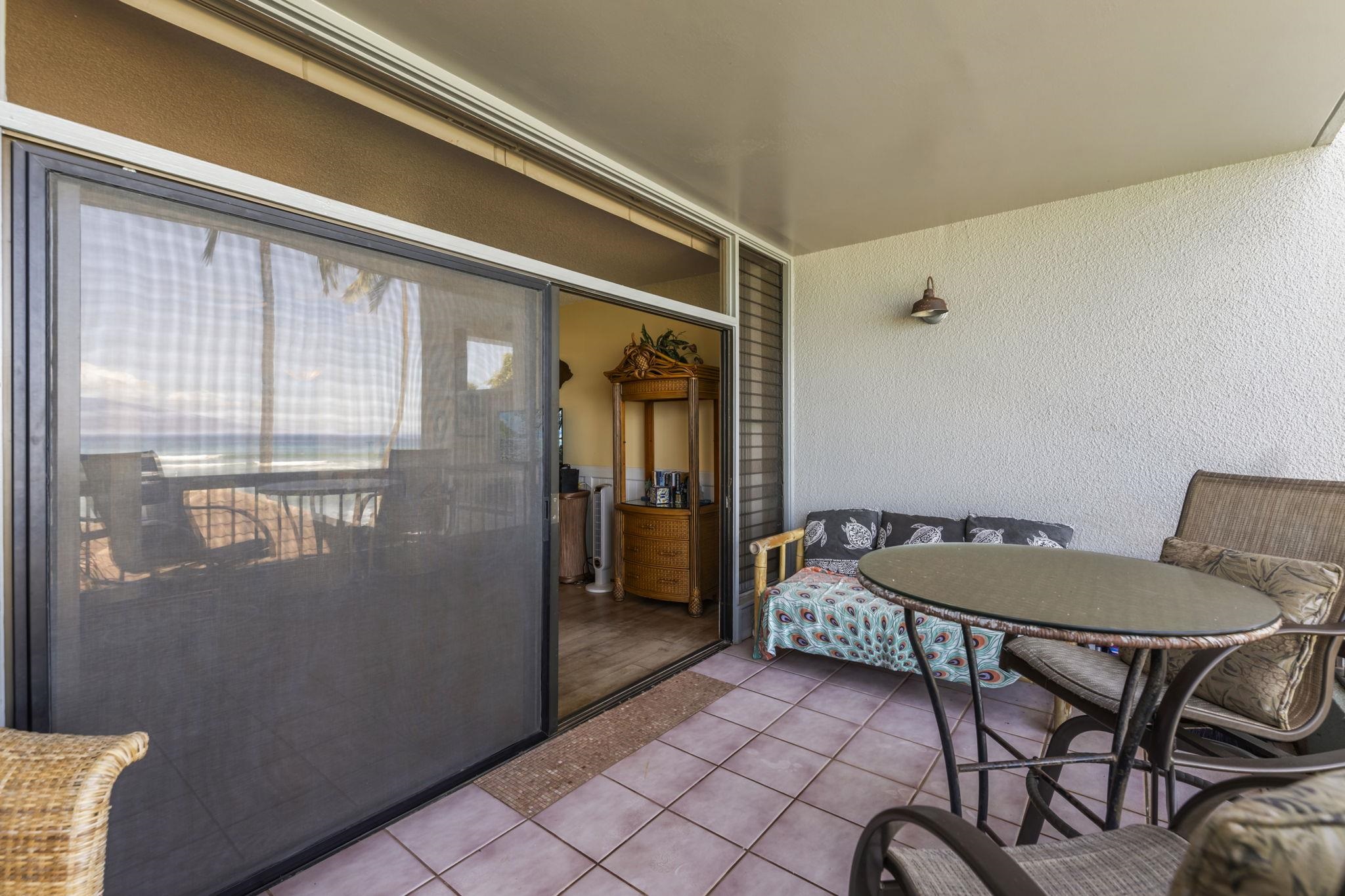 3875 Lower Honoapiilani Road, Unit B205 Lahaina, HI 96761 - Photo 20 of 28 a balcony with table and chairs
